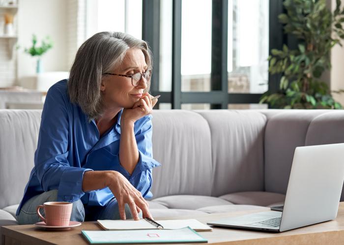 woman sitting on couch with laptop